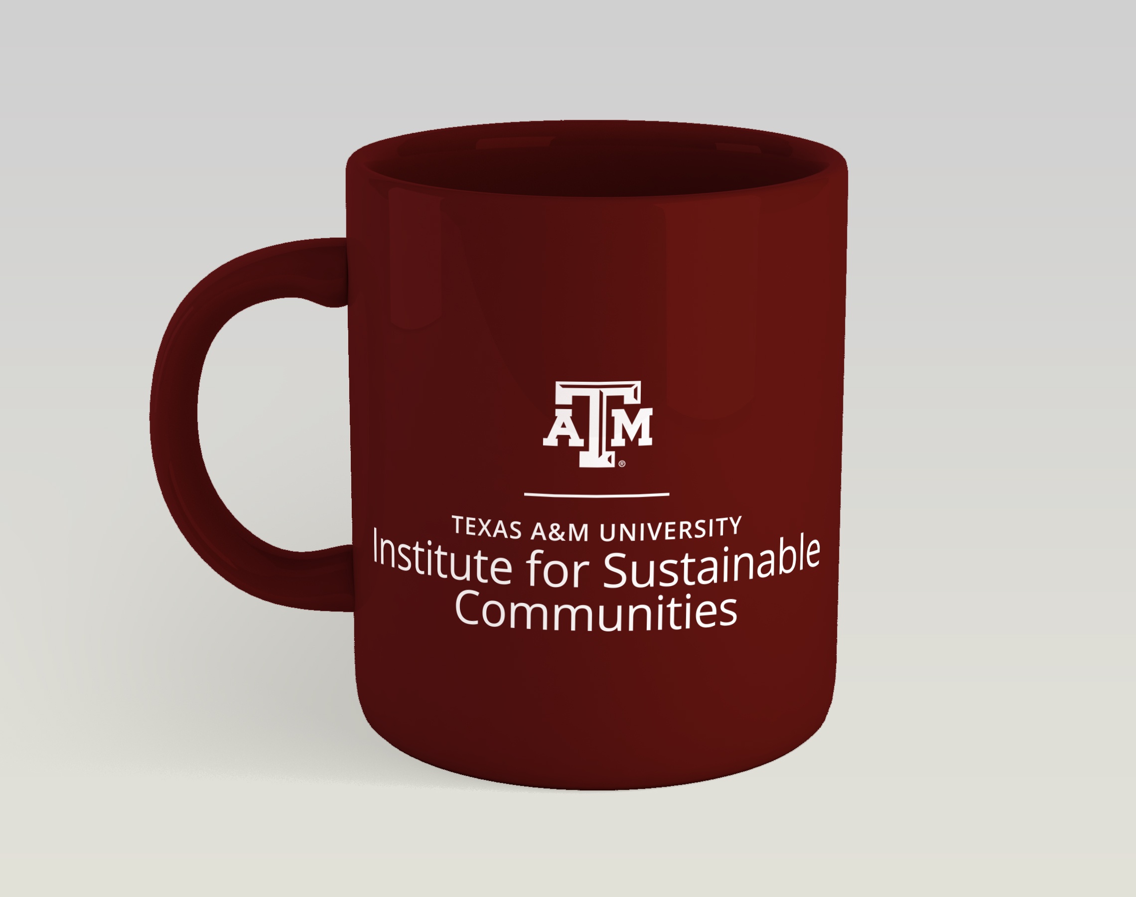 A one-color, stacked white lockup for the Institute for Sustainable Communities displayed on a solid maroon mug